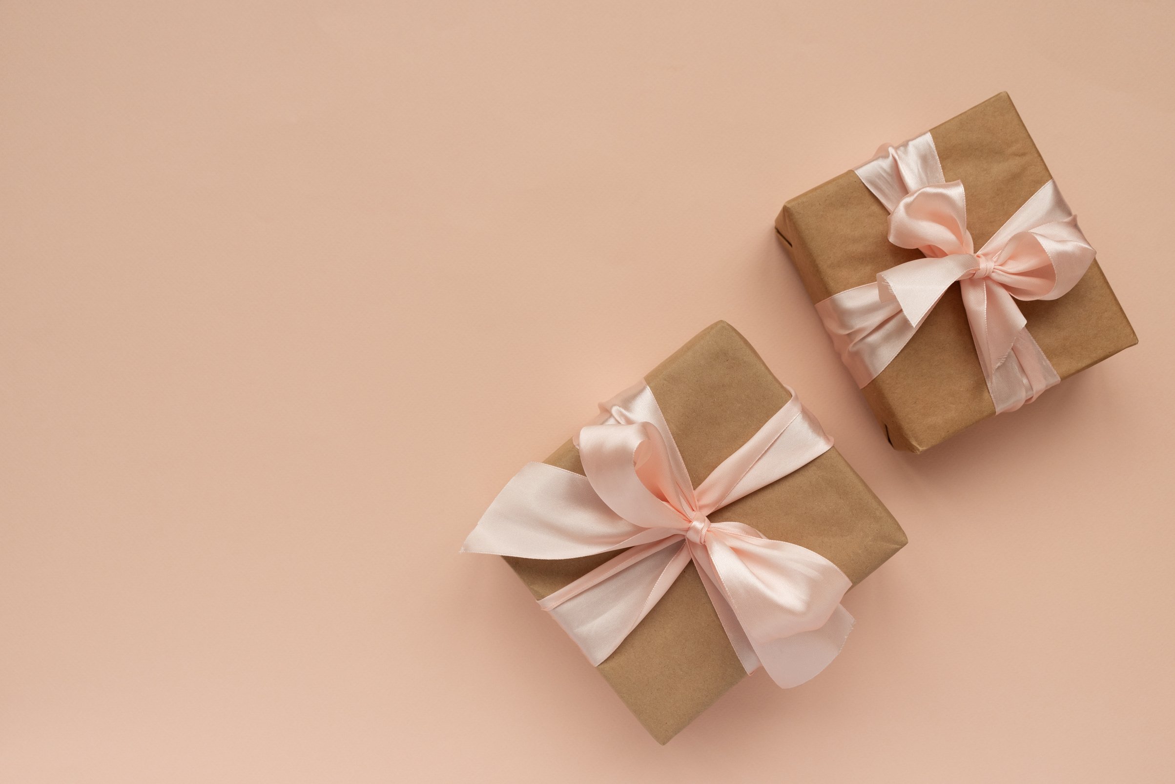 Gift Boxes with Ribbons on Peach Background